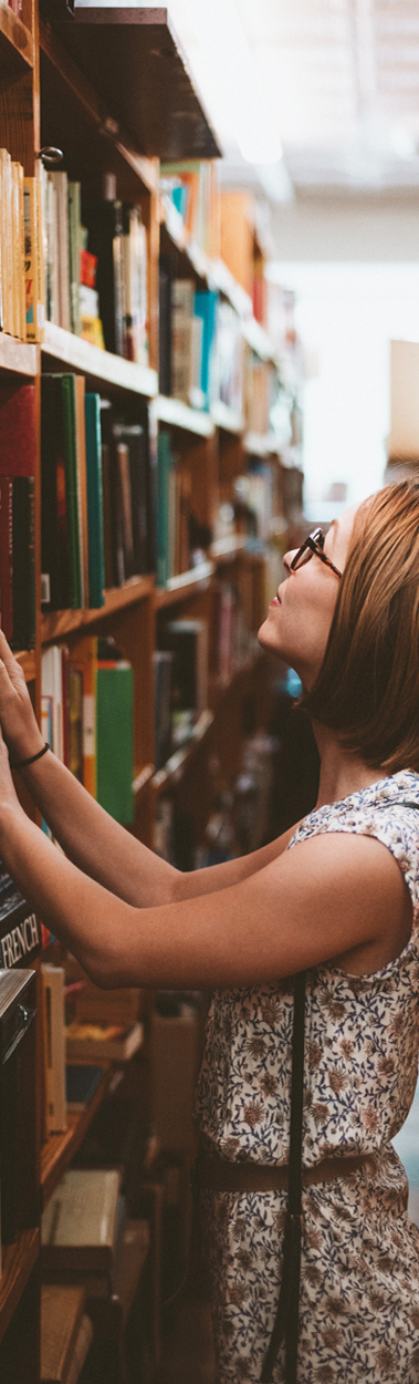 women looking at a library shelf